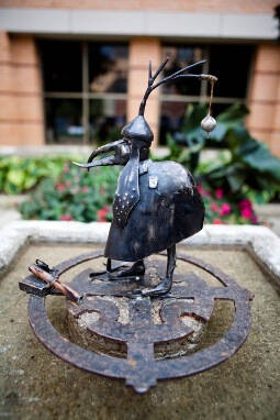Small metal bird sculpture.